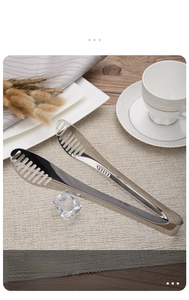 Detail of thickened stainless steel food tongs with hollow striped anti-slip head design