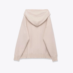 Detail view showing the back of a beige knitted hoodie with ribbed cuffs and hemline