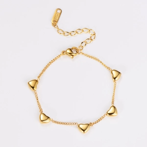 Detail of 18KGP gold heart bracelet showing engraved hallmark and lobster clasp