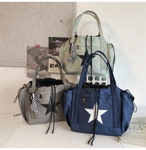 Three nylon tote bags with star print, drawstring closure, and checkerboard heart charms