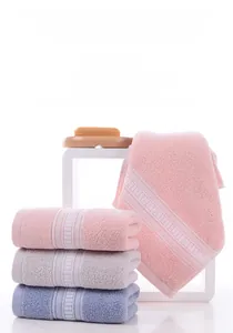 Macro detail of soft combed cotton towels with jacquard patterns in pink, grey and blue colors