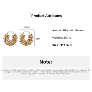 Detail view of gold U-shaped rhinestone earrings measuring 3x2.5cm and weighing 20.4g