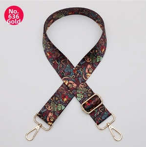 Close-up of Bohemian patterned wide strap with gold-tone metal lobster clasps and buckles