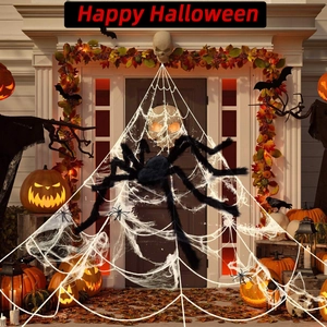 Giant black plush Halloween spider with glowing eyes and realistic web on a porch
