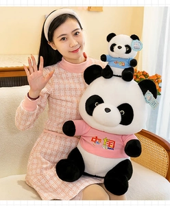 Close-up of two adorable panda plush dolls wearing pink and blue T-shirts