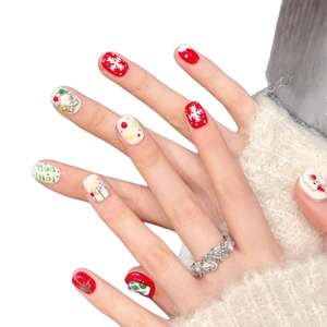 Handmade Christmas press-on nails featuring Santa, snowflakes, and festive wreaths