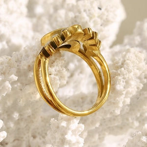 Macro detail of 18K gold-plated double-layer ring featuring sun-motif zircon inlays