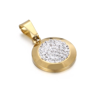 Macro shot of circular gold pendant featuring sparkling clear crystals and polished finish