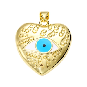 Detailed close-up of a golden heart-shaped evil eye pendant with blue enamel and zircon inlay