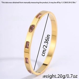 Detail view of pink zircon inlay on a golden stainless steel bangle with dimensions