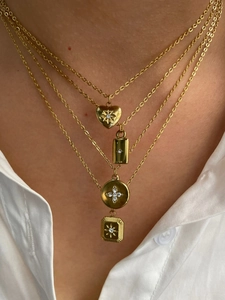 Detail view of gold layered necklaces with heart, bar, round and square diamond pendants