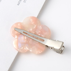 Detailed back view of flower-shaped hair clip showing silver metal duckbill clamp and pearly finish
