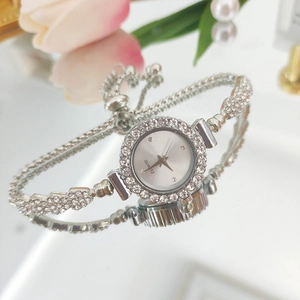 Detailed view of silver quartz watch with rhinestone strap and adjustable toggle clasp