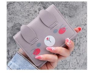 Close-up of grey PU leather short wallet featuring cute 3D bunny ears and cartoon print