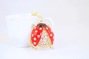 Detail of red rhinestone beetle keychain with gold finish and lobster clasp