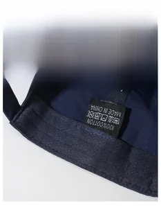 Detail of the 100% cotton inner sweatband and care label on a blue baseball cap