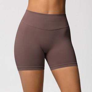Macro view of seamless high-waist yoga shorts showing the ribbed texture and tummy control fabric