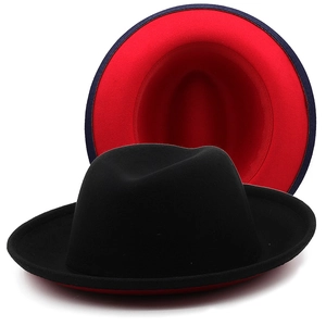 Detail view of two-tone wool fedora hat featuring contrast black exterior and red interior