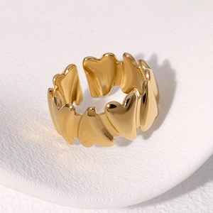 Adjustable golden heart ring with multiple linked hearts and polished metallic finish