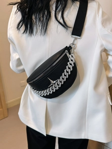 Detail of crossbody chest bag with silver chain and star logo on black textured leather