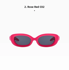 Detail view of bold rose red Y2K oval sunglasses with thick frames and dark grey lenses