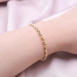 Adjustable C-shaped golden titanium steel cuff bracelet with textured geometric bead design