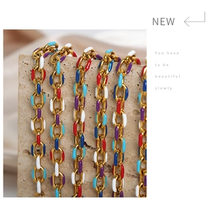 Detail of colorful enamel gold chain links featuring vibrant red blue and white glaze