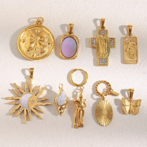 Detailed close-up of 18K gold plated stainless steel pendants with zircon and shell inlays