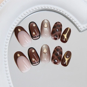 Golden brown cat eye press-on nails with leopard print, french tips and rhinestones