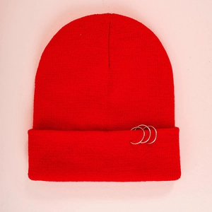 Détail du bonnet en tricot rouge d'hiver avec trois anneaux métalliques argentés décoratifs