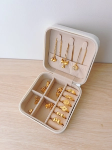 Macro detail of portable jewelry box with velvet slots for rings and necklace hooks