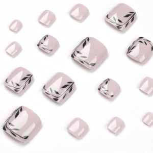 Glossy pale pink press-on toenails with elegant black leaf patterns on white background