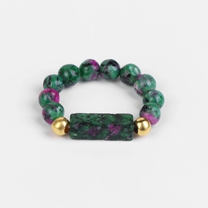 Macro detail of a 4mm Ruby in Zoisite beaded ring with rectangular stone and gold accents