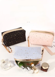 Detailed set of three cosmetic bags in black pink and blue with gold star patterns
