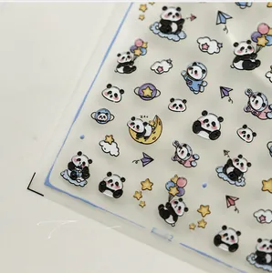 Close-up of KX352 3D panda nail art stickers with astronaut and cloud motifs