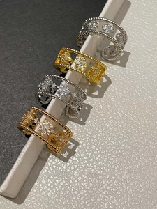 Detail view of double-layer clover rings featuring micro-set zircon and beaded texture