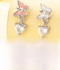 Detailed view of butterfly cartilage stud with pink wings and heart-shaped zircon