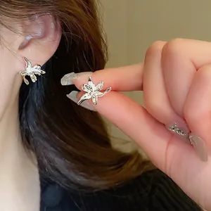 Elegant silver lily flower stud earrings with a sleek liquid metal mirror finish