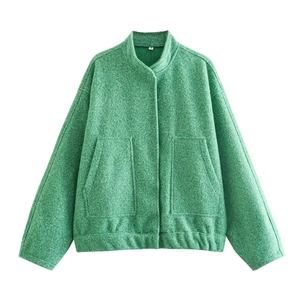 Detailed macro view of green mixed texture knit fabric on bomber jacket with pocket