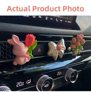 Three-piece car vent clip set with pink rabbit and tulip motifs on a modern dashboard