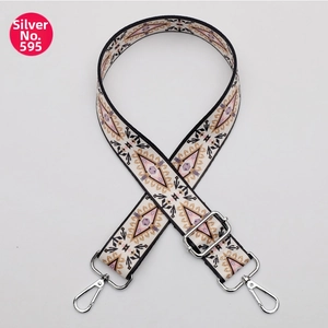 Detail of colorful ethnic geometric handbag strap with silver metal swivel hooks
