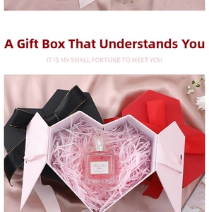 Macro view of heart-shaped gift boxes with silk ribbon bows and decorative paper fill