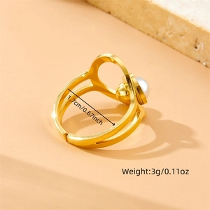 Detailed view of adjustable gold-toned ring with round pearl and 1.7cm inner diameter