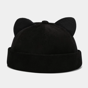 Detail of black corduroy docker hat featuring cat ear design and ribbed texture