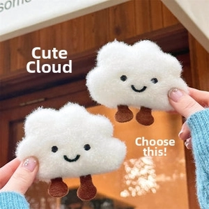 Pair of cute plush white cloud accessories with embroidered smiling faces and tiny legs
