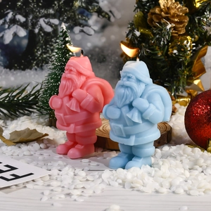 Detailansicht der brennenden Weihnachtsmann-Kerzen in einer verschneiten Festtagsdekoration