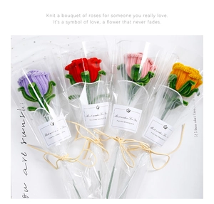 Detailed view of handmade chenille rose bouquet in purple red and pink festive packaging