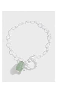 Detailed macro view of S925 silver chain bracelet with green jade stone and toggle clasp