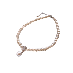 Elegant pearl necklace with a zircon-encrusted teardrop pendant on white background
