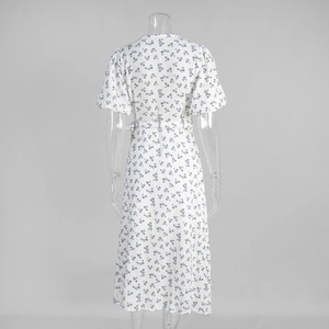 Back view of floral cotton dress featuring puff sleeves and matching waist belt
